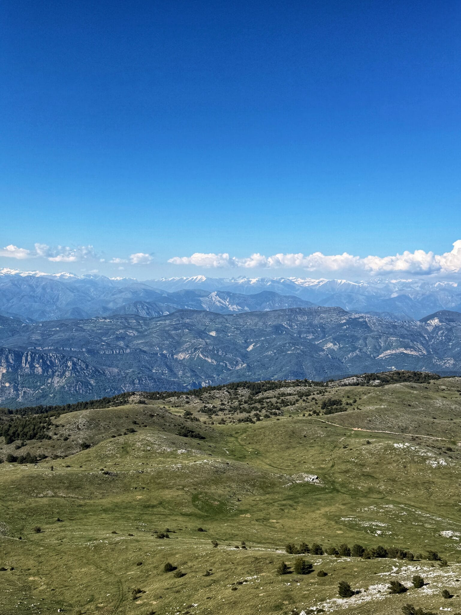 Panorama of the snow-covered reliefs of the Southern Alps, playground for paragliding